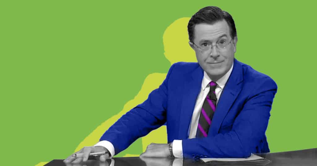 A man engaged in candidate engagement at a desk with a green background.