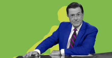 A man engaged in candidate engagement at a desk with a green background.